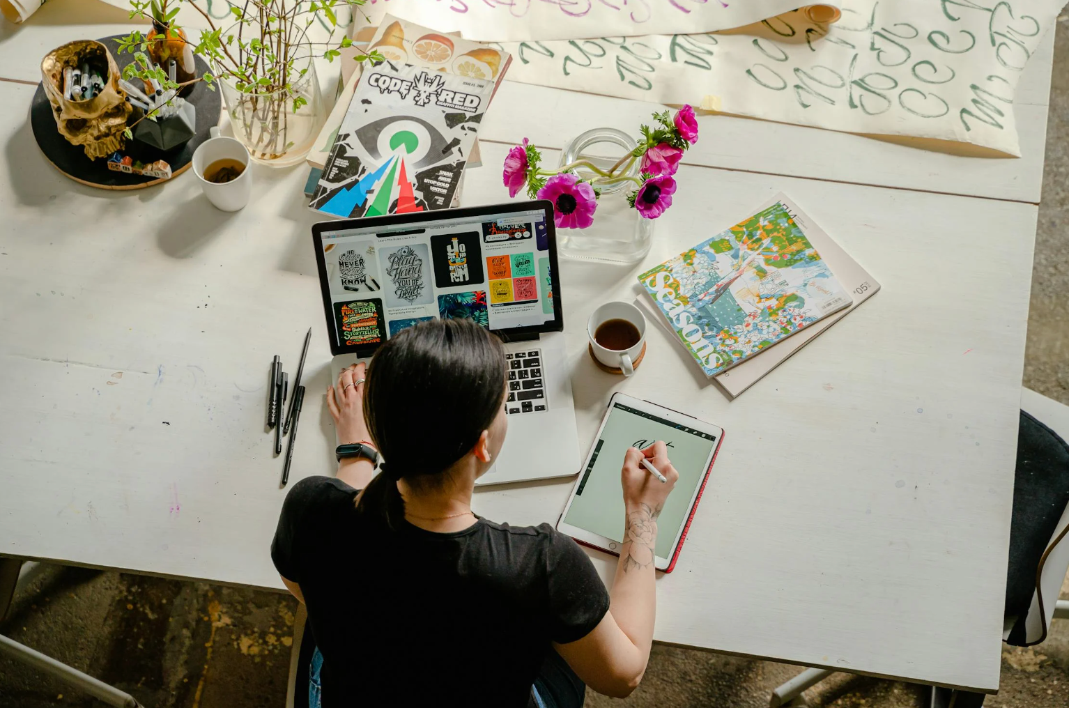 Busy woman working on her desk with many different tasks 